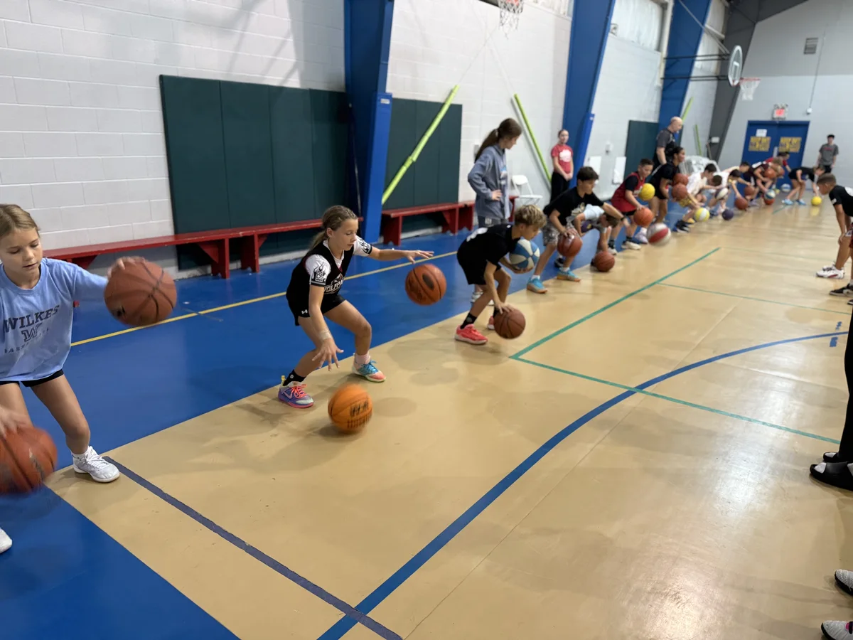 Kids working on dribbling along the court during the one-day clinic